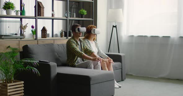 Young Couple Trying Virtual Reality Headset at Home