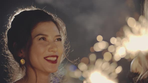 Portrait of Asian and Caucasian Girl at Party or Holiday Evening Smiling, Laughing, Celebrating