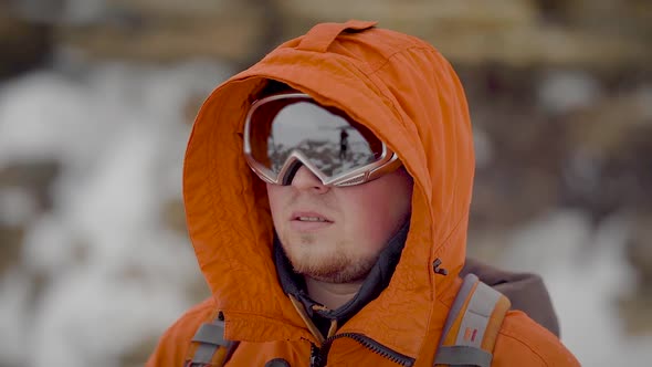 Close-up Shot of a Hiker in Big Ski Glasses Trekking in Mountains.