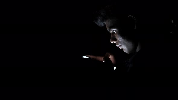 Young Man Using Smart Phone at Night 