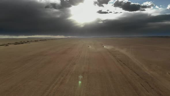 Vehicles Driving on Wide Dirt Roads in Central Asian Steppes