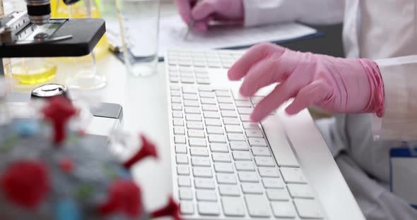 Doctor is Typing on Keyboard in Laboratory Closeup