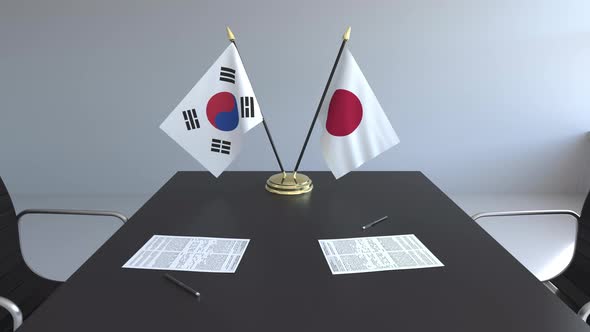 Flags of South Korea and Japan and Papers on the Table