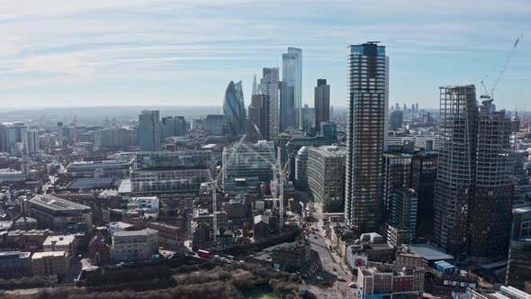 Cinematic rotating city of London drone shot of business district skyscrapers bishopsgate