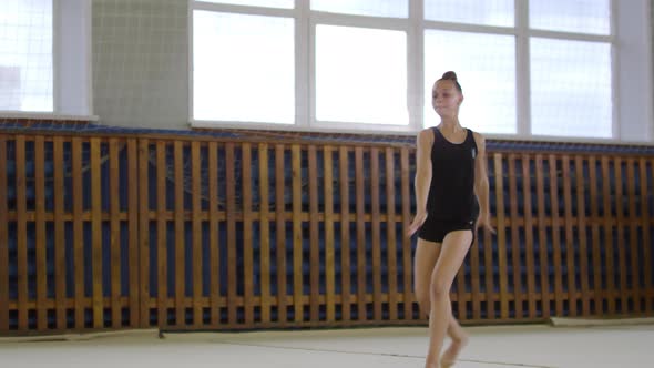 Teenage Girl Doing Split Jumps