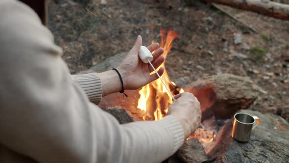 Closeup of Male Hands Putting Marshmallow on Stick and Roasting Dessert on Fire