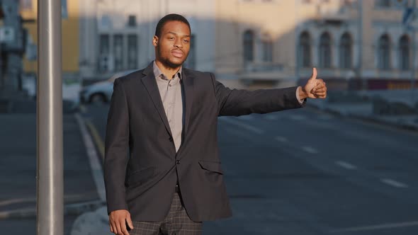 Confident Calm Mixed Race Young Adult Businessman Wearing Suit Raising Hand Showing Thumb Up