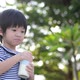 Cute Asian Child Drinking Milk From Glass Bottle - VideoHive Item for Sale