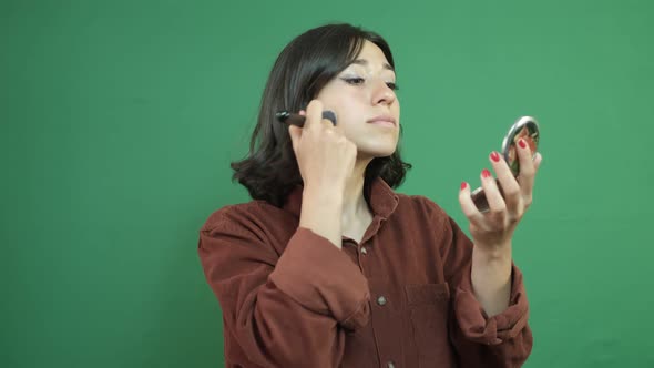 Makeup In Front Of Green Curtain