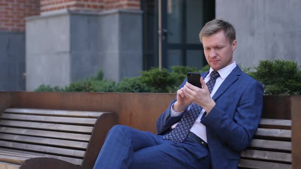 Tense Frustrated Businessman Reaction While Using Smartphone