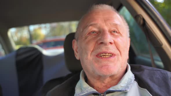 Close Up Portrait of Happy Caucasian Elderly 80s Man in Car, Active Relaxed Pension.