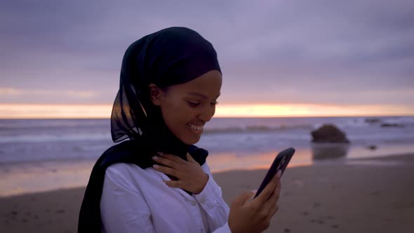 Somali-American woman checking her social media