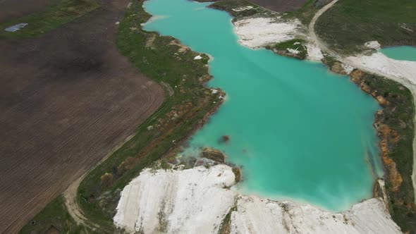 Aerial drone view Amazing industrial landscape, on Emerald lake in a flooded quarry