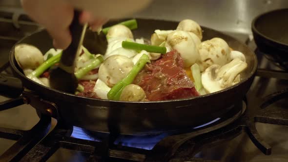 Cooking Sliced Beef Meat With Vegetables And Mushrooms In A Pan. Korean Beef Bulgogi. close up