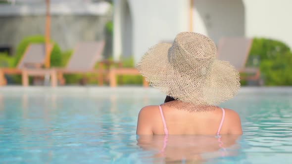 Young asian woman enjoy around outdoor swimming pool for leisure