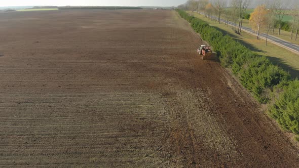 Aerial Tractor Spreads Manure on Farmland