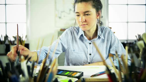 Woman painting with watercolor paints