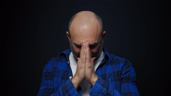 Man Looks at the Camera and Begging Young Man Prays Excitedly alt