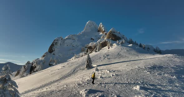 Fly Over and Around the Mountains of Ciucas Romania in January 2022 Sunny Day