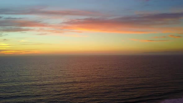 Aerial drone view of a sunset at the beach over the ocean