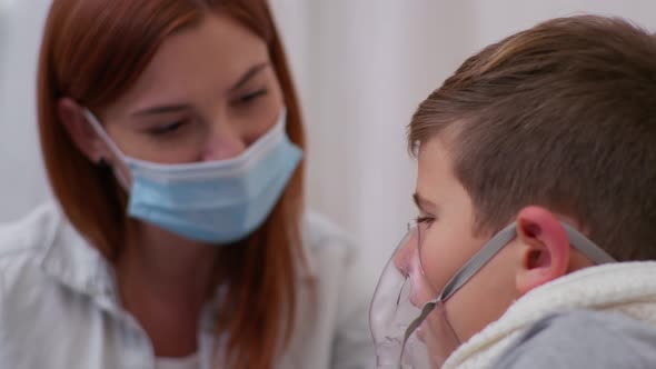 Little Male Child with Symptoms of Dangerous Illness Coronavirus and Pneumonia Uses an Inhaler To