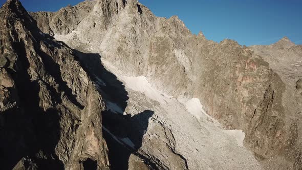 rocky summits in the swiss alps, blue sky. aerial drone view