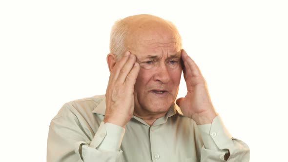 Senior Man Having a Headache Rubbing His Temples