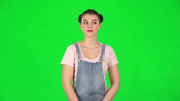 Playful Girl Funny Coquetting and Blowing a Kiss on Green Screen