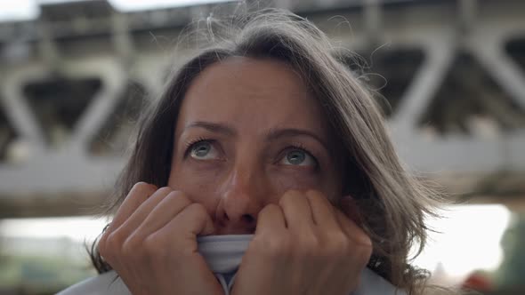 Closeup of a Female Face Under a Railway Bridge