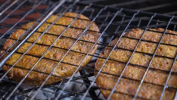 Close Up of Vegan Meat Patties in Nonstick Grilling Basket. Making Vegan Burgers on Barbecue. 