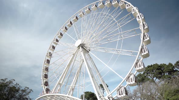 Ferris wheel attraction rotating in the park