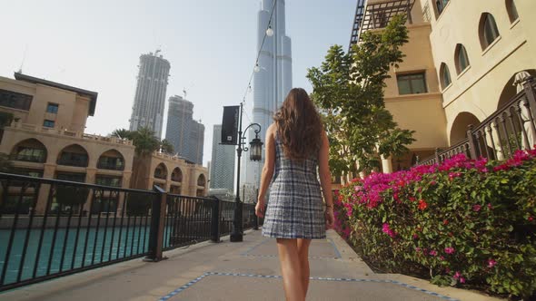 Woman Walking Through Luxury Apartment Complex Near Burj Khalifa Skyscraper in Dubai
