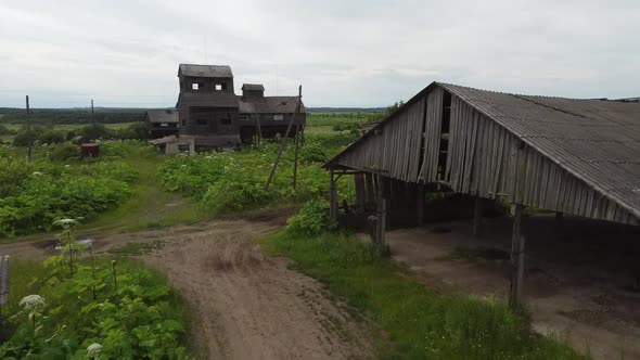 Fly Over Dirty Road Through Abandoned Village and Granary