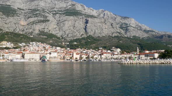 Makarska Harbor In Croatia Below Mountain