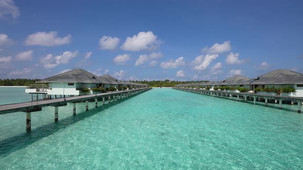 Slow Motion of Luxury Overwater Villas on Blue Lagoon White Sandy Beach Maldives Islands