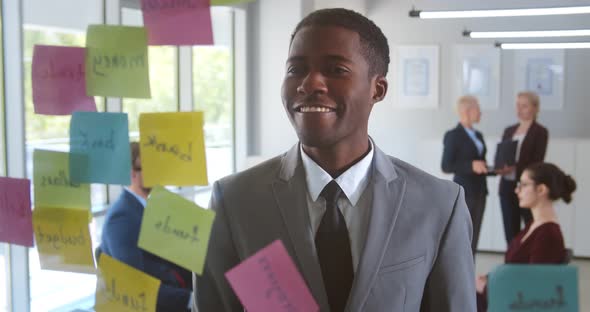 Smiling African American Male Employee Write on Colorful Sticky Notes Develop Business Project in