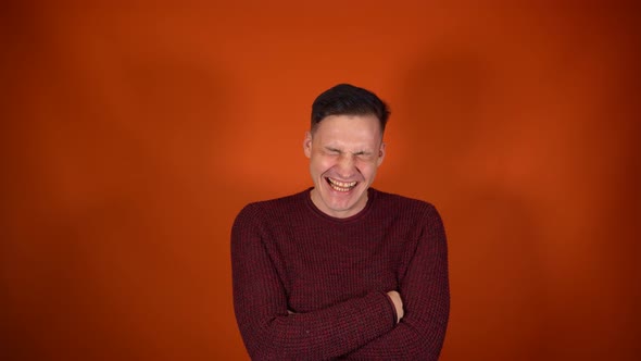 Portrait of Laughing Man on Orange Background