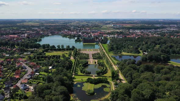 Aerial View Of Frederiksborg Castle, Park, Lake, And Garden In Hillerod, Denmark. - pullback