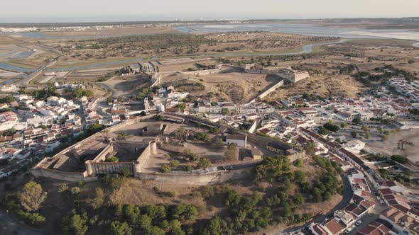 Dolly in aerial view of the remains of heritage castle and fortification in Castro Marim, Algarve