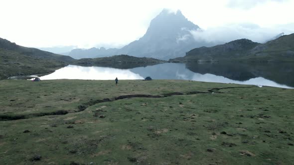 Aerial Forward Movement Shot of Tent Beside the Lake Ayous and Beautiful Mountain Range in the