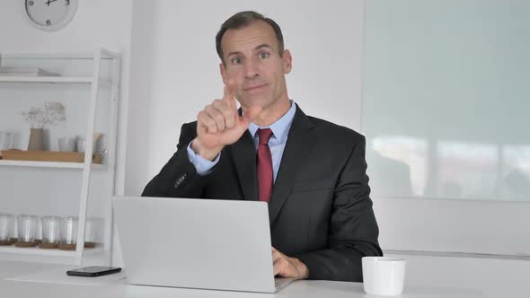 Pointing Gesture By Middle Aged Businessman