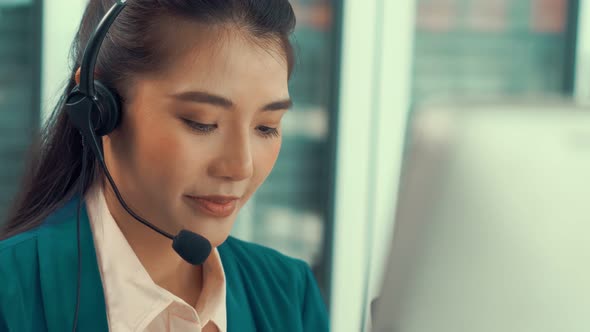 Businesswoman Wearing Headset Working Actively in Office