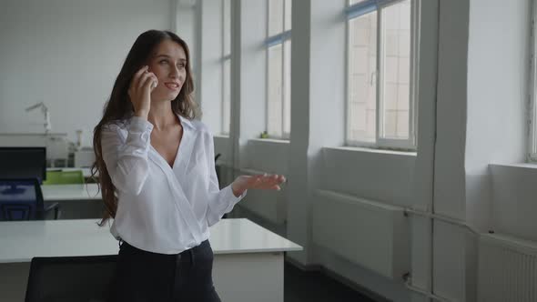 Worker Stands and Speaks on Her Black Phone