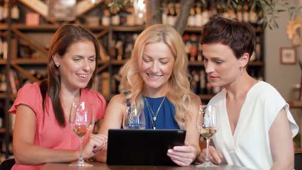Women with Tablet Pc at Bar Wine or Restaurant 