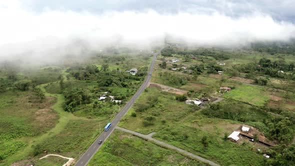 Aerial view of a highway with a public bus and cars driving over the road