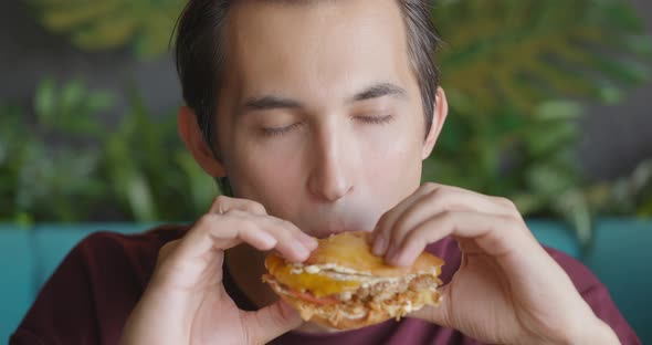 Close Up Shot of Handsome Men are Eating Burger in Fast Food Restaurant