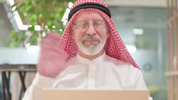 Old Arab Businessman Doing Video Call on Laptop