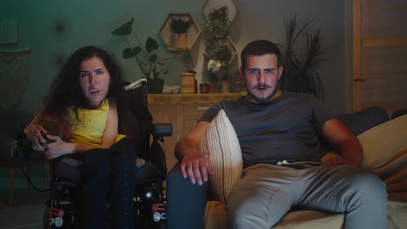 Woman with Disability and Man Watching TV