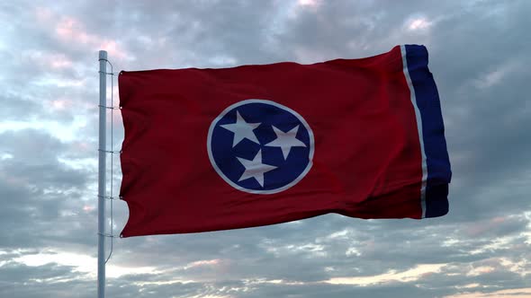Realistic Flag of Tennessee Waving in the Wind Against Deep Dramatic Sky