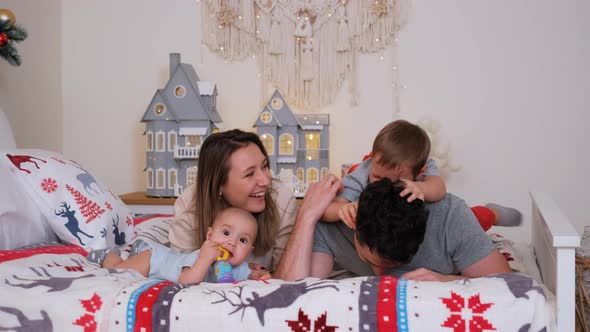 Big Family Having Fun While Lying on Bed at Home